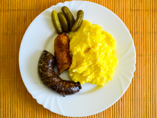 Fine hungarian sausages with potato on white plate