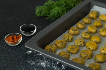 Salted cookies with dill and black cumin in the tray.

