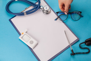 World Diabetes Day. Medical tablet with white sheet of paper, glucometer with a strip test