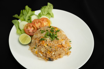Fried rice with egg and grilled salmon on black background  -Stock photo