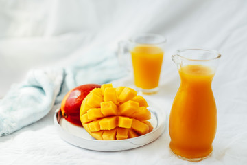 mango with mango juice in a glass jug. a glass of juice.