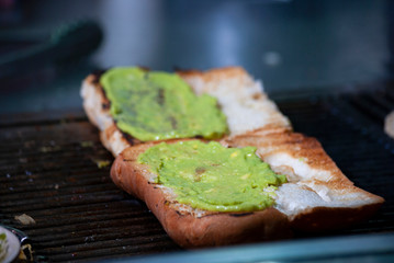 Fast food prepared on the street in Guatemala, Central America, bread with sausages, cabbage, avocado and sauces, called Shuco Chapina version of hot dog, danger of contagion of diseases and Covid 19.