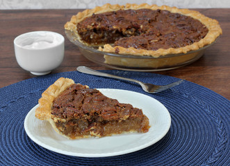 Pecan Pie Slice with whole pie in background