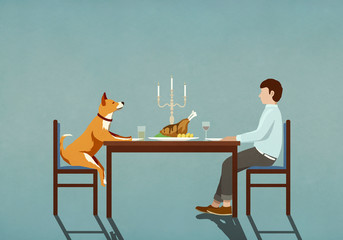 Man and dog enjoying candlelight dinner at table