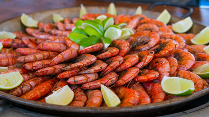 Close-up of ready to eat delicious grilled tiger shrimp with lime. Concept of healthy eating,...