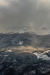 Light shining through clouds on mountains
