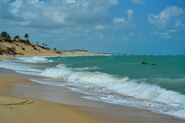 Small boat with fisherman in Pipa beach, Tibau do sul, near Natal, Rio Grande do Norte, Brazil on September 25, 2016