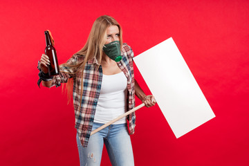 Emotional young blonde woman with a white banner for slogans in her hands expresses a protest and...