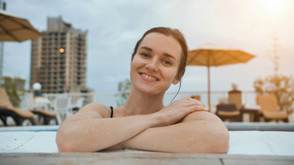 Girl after swimming posing in the pool.