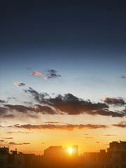 Beautiful colorful sunset over city apartment buildings