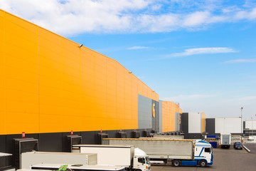 Cargo trucks at warehouse building