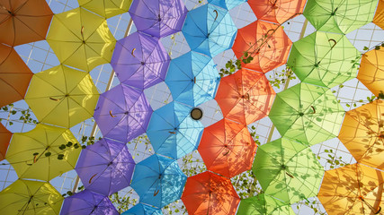 Multi-colored umbrellas in the park of the city.