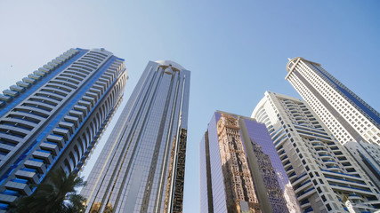 Fototapeta na wymiar Tall and modern skyscrapers of Dubai on a sunny day.