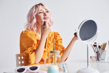 Beautiful woman doing make up with brush