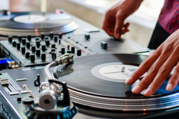 Male DJ on turntable spinning vinyl records