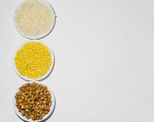 Set of colors food rice millet buckwheats on the plate on the white background