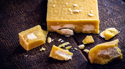 rapadura cut on rustic wooden table. Sugar cane candy, Brazilian dessert.