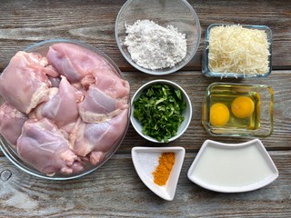 Products for cooking meat and chicken cutlets are spread out on a wooden table. Ready to cook in the kitchen