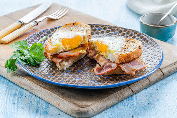 Egg-in-the-hole bacon sandwich - cut in half