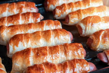 Close-up of fried sausages in the dough. Homemade cake