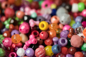 Fototapeta na wymiar Close up of colorful child's plastic beads for home projects