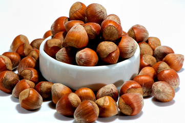 hazelnuts in a bowl isolated on white