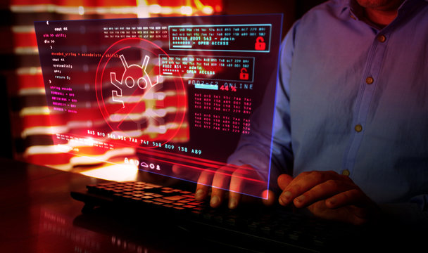 Man typing on keyboard with virus detected alert on hologram screen