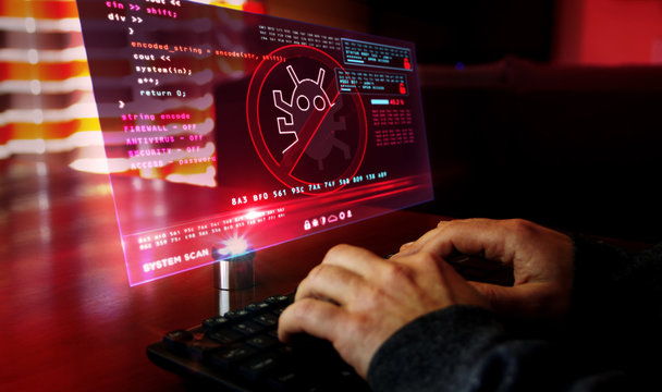 Man typing on keyboard with virus detected alert on hologram screen