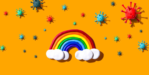 Fototapeta premium Hopes and wishes for the coronavirus situation with clay rainbow and viruses