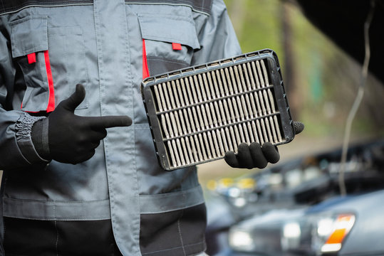 A Car Service Worker Is Showing In Hands Old Car Air Filter Close Up.