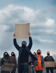 Diverse group of people protesting with blank sign. Protest against human rights, abuse of freedom...