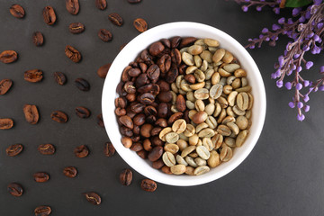 Coffee beans and bowl on stone background. Top view with copy space for your text