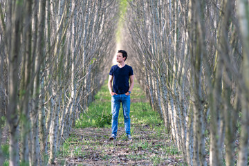 Naklejka na ściany i meble The man experiences a feeling of loneliness on a walk through the woods