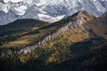 View from Kreuzeck into the valley Reintal and snow covered mountains of Wetterstein mountain chain during autumn, Garmisch-Partenkirchen Bavaria.