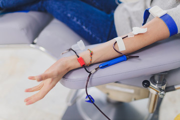 laboratory blood is removed during donation. hand close-up.