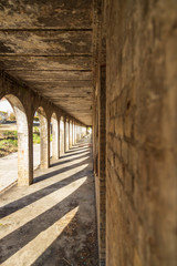 old abandoned brick building with arches and a long corridor with a vanishing point single point...