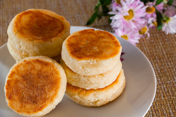 Cheese pancakes with jam on a plate on a brown background. Breakfast food