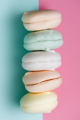 multicolored marshmallow on pink background. colorful sweets. delicious and beautiful zephyr. Copy space