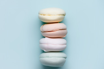 multicolored marshmallow on blue background. colorful sweets. delicious zephyr.