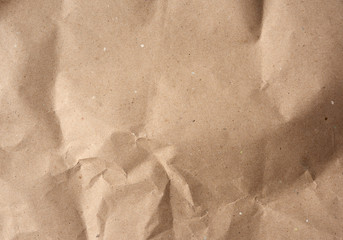 Naklejka premium crumpled blank sheet of brown wrapping kraft paper, vintage texture for the designer