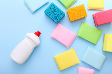 Colored kitchen sponges on blue background. Kitchen cleaning set