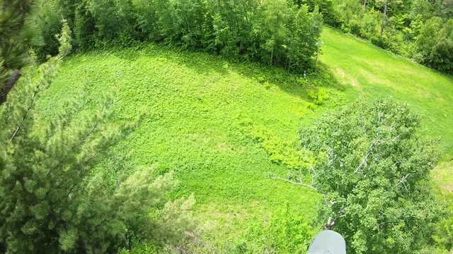 Fun Point Of View (POV) GoPro Shot Of Man On Zipline (zip Line) Flying Above Trees In Forest, Enjoying Excitement Of Outdoor Summer Activity.