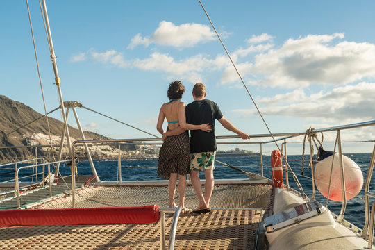 Couple hugging on a boat in the atlantic ocean by Tenerife