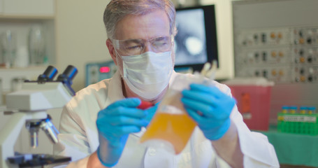 A medical professional working in a laboratory labels a bag of blood plasma preparation to be used to fight COVID19.