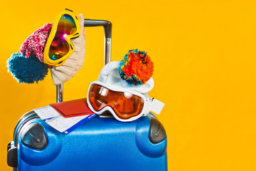 ski suitcase boots and accessories for a ski resort on a yellow background in the studio, winter...