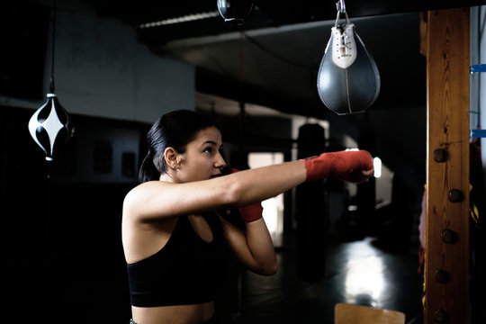young woman practicing boxing at the gym