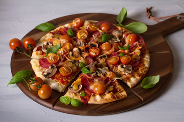 Tasty pizza and fries on wood serving board, white background. Horizontal image