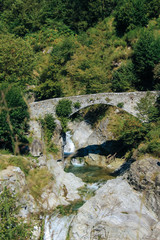 Fototapeta na wymiar old stone bridge in italy near lake como with waterfall