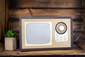 Old vintage radio on wooden background