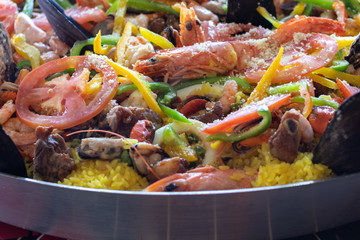 Clouse up on paella inside pan with sea swipes showing shrimp